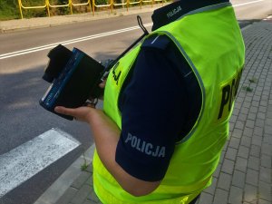 Policjantka z ręcznym miernikiem prędkości.