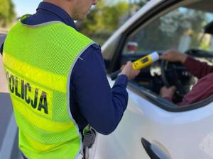 Policjant bada stan trzeźwości kierowcy