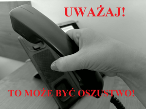 Dłoń podnosząca słuchawkę telefonu. Napis: Uważaj! To może być oszustwo!